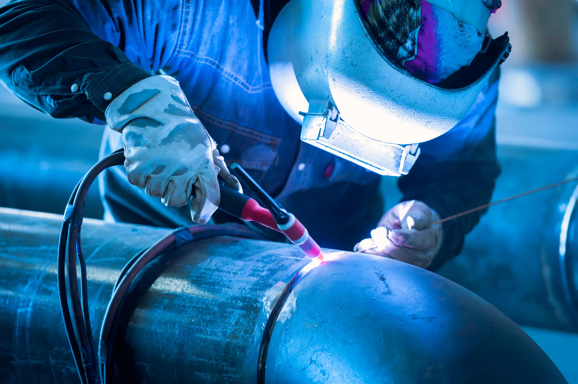Worker welding metal