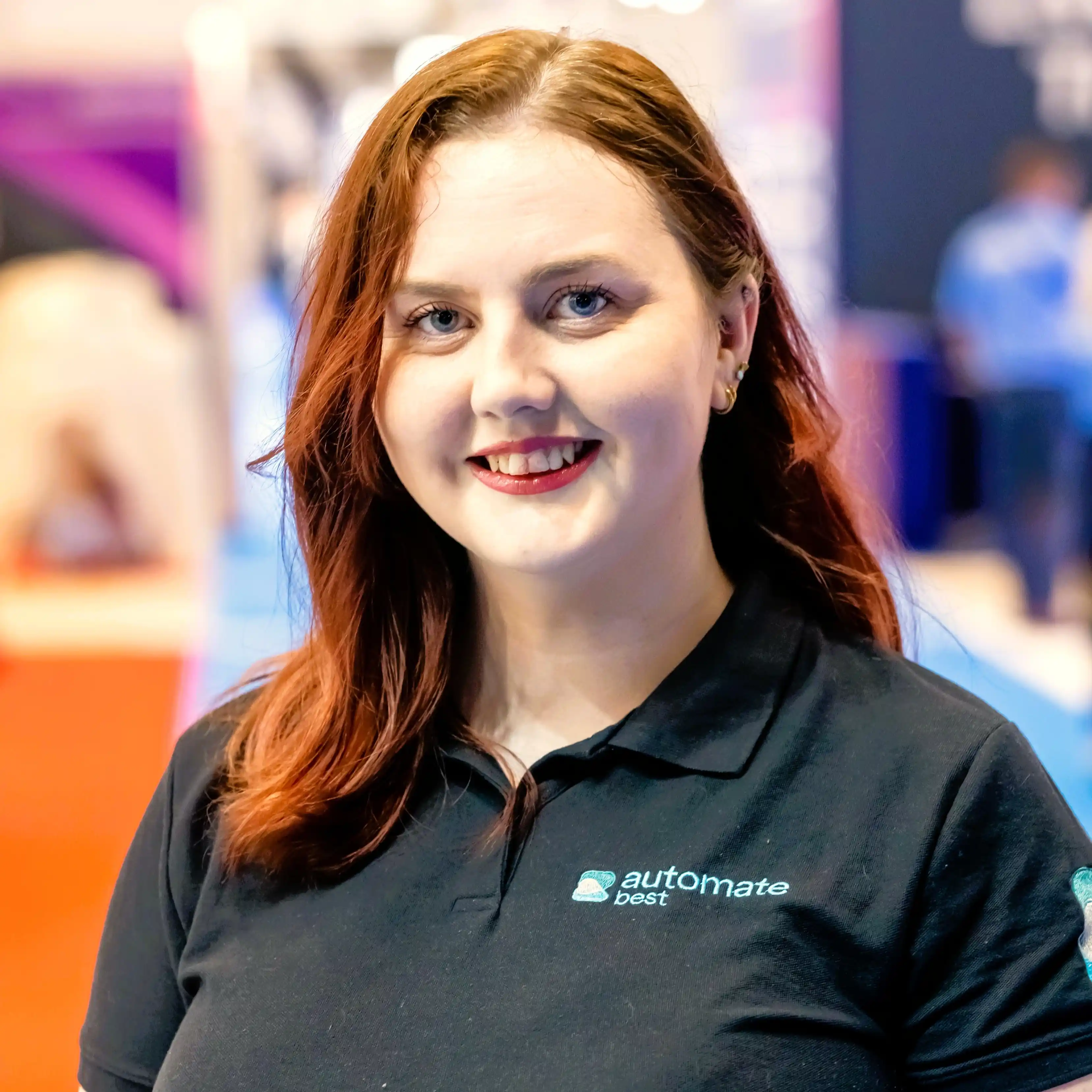 A female with red hair wearing dark t-shirt