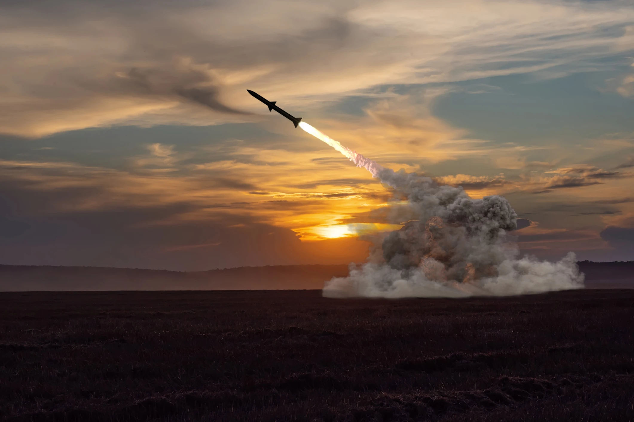 Rocket launch against the background of the evening field, the setting sun