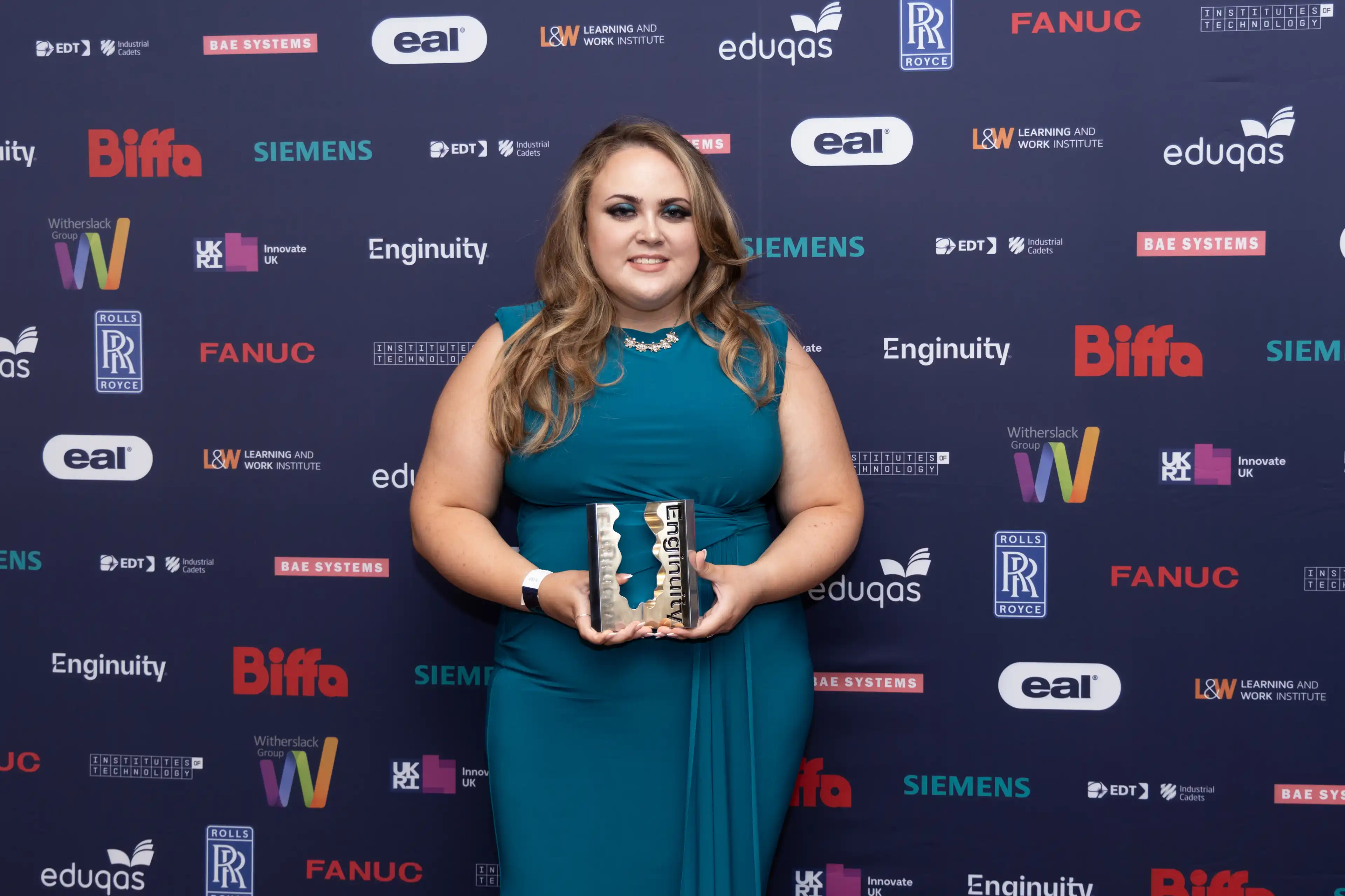 A picture of an award winner collecting their award for graduate, degree or higher apprentice of the year