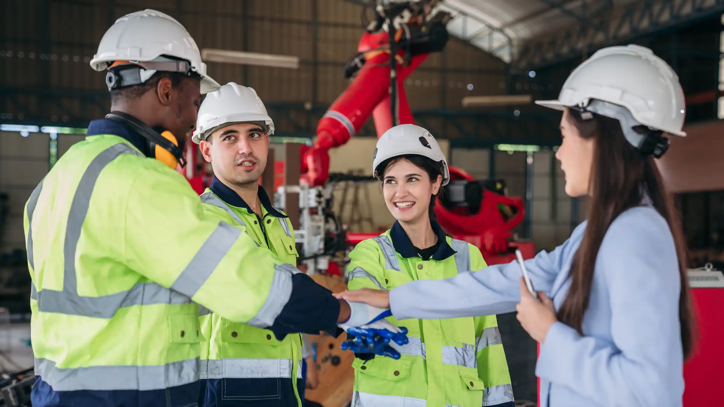 Engineers high fiving in their safety gear