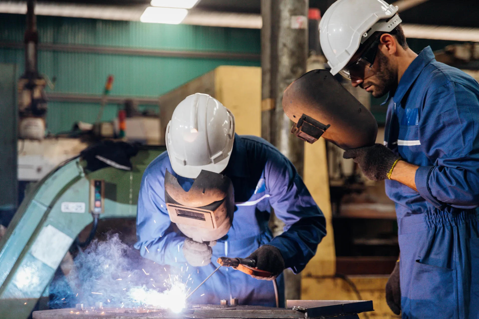 Two welders in a workshop
