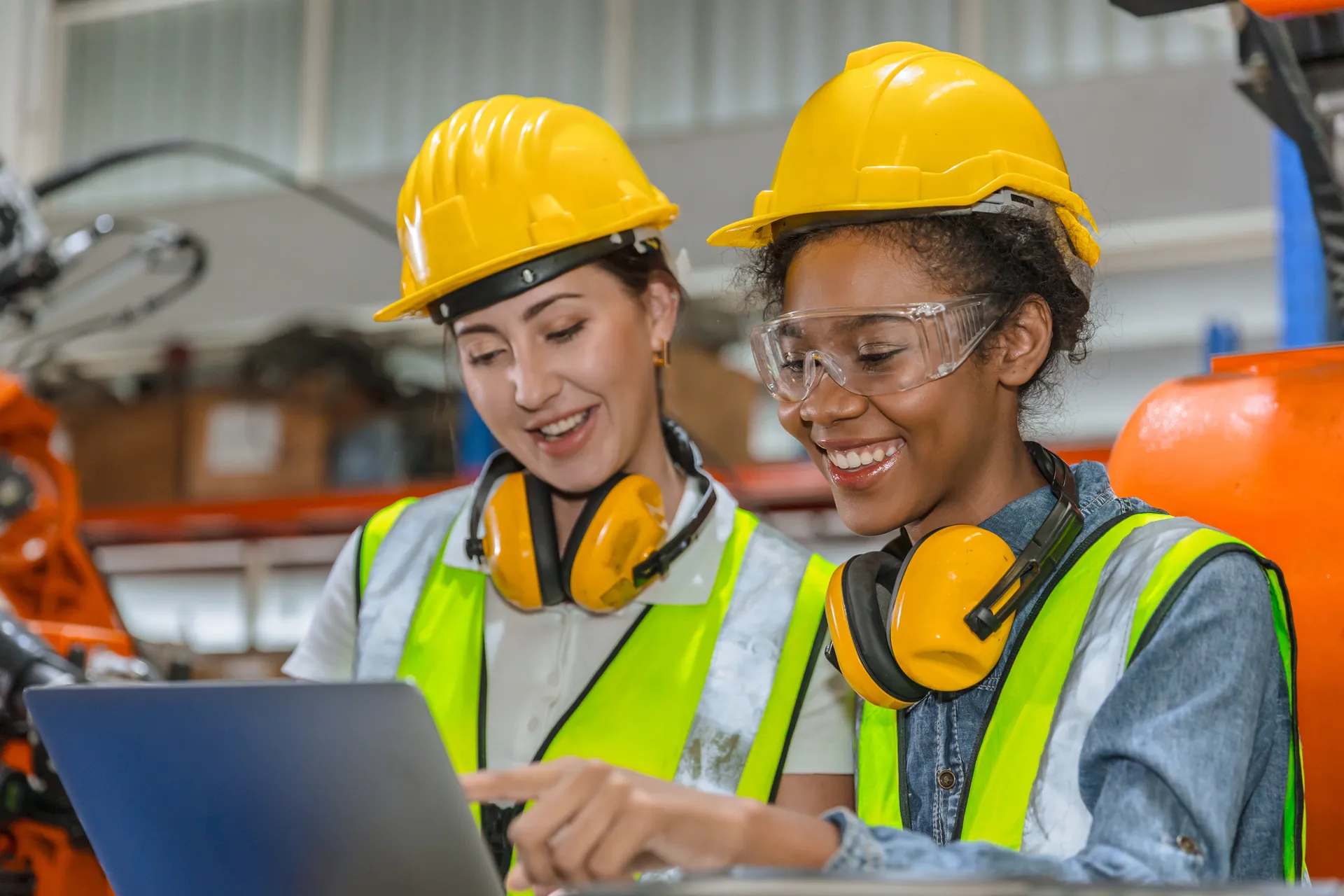 Engineer training, technician work in modern factory industrial robot welding arm machine control operator