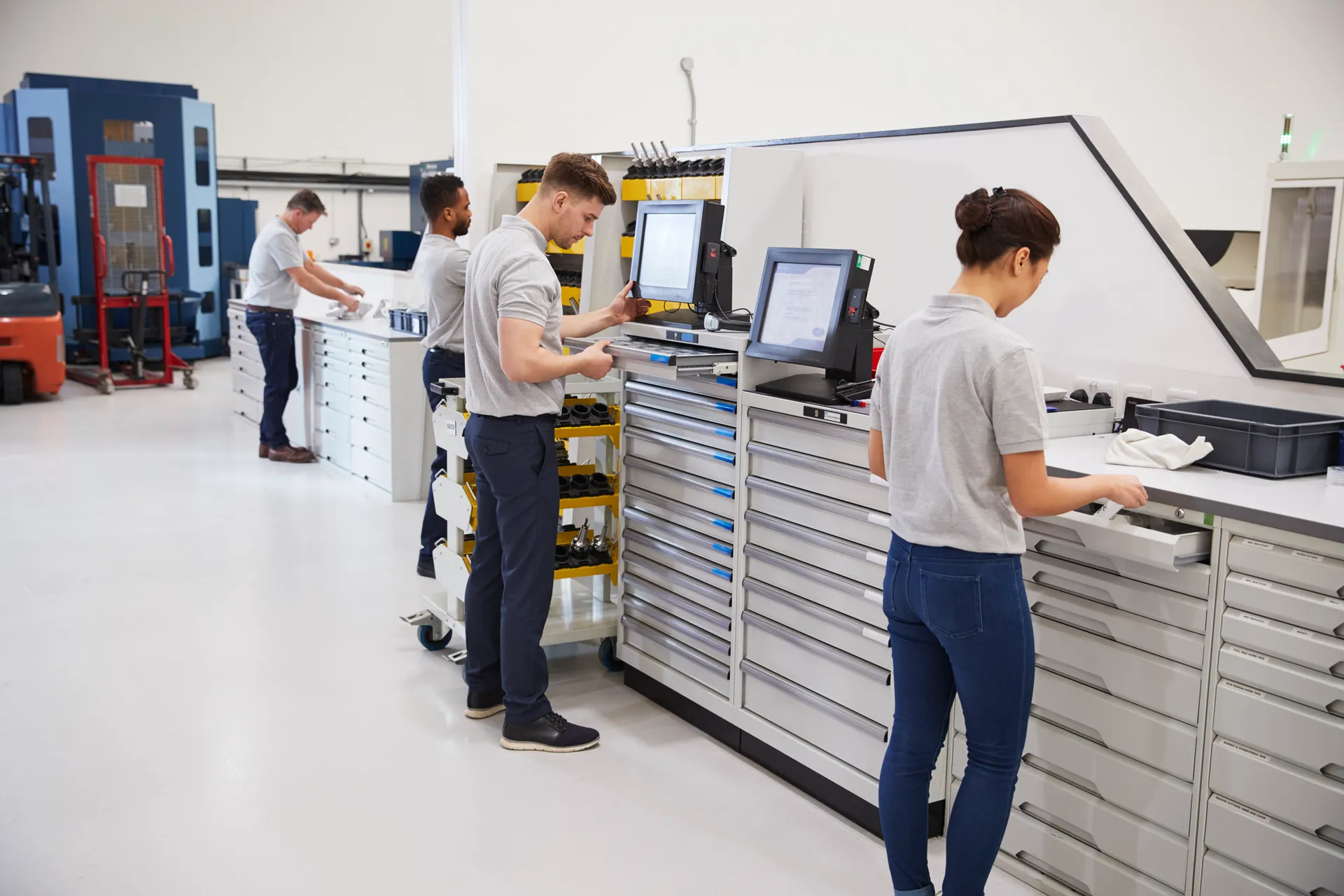 Engineers Selecting Tools For Use On Machinery In Factory