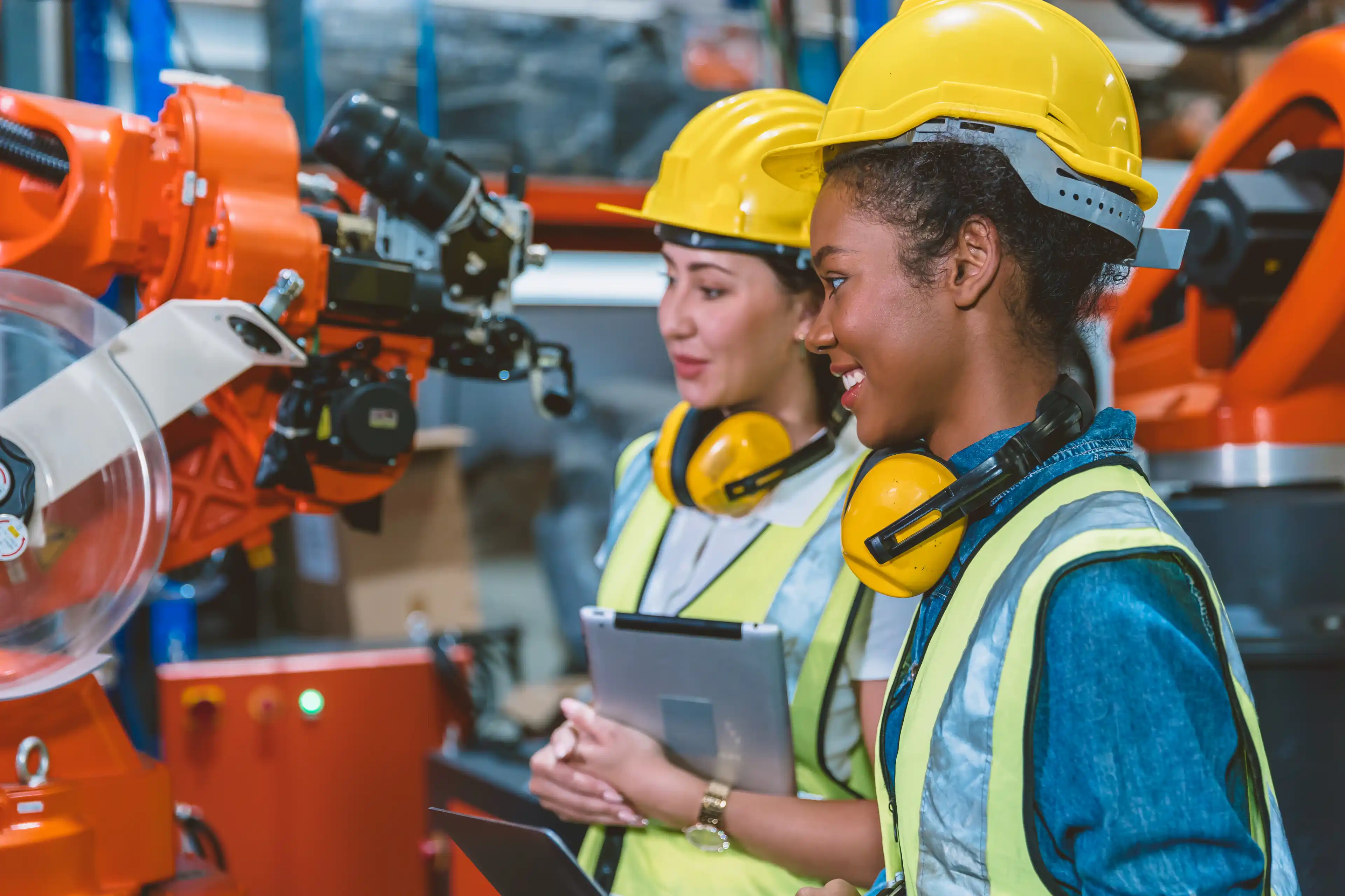 Women engineer worker working team helping together at work in modern advance machine factory