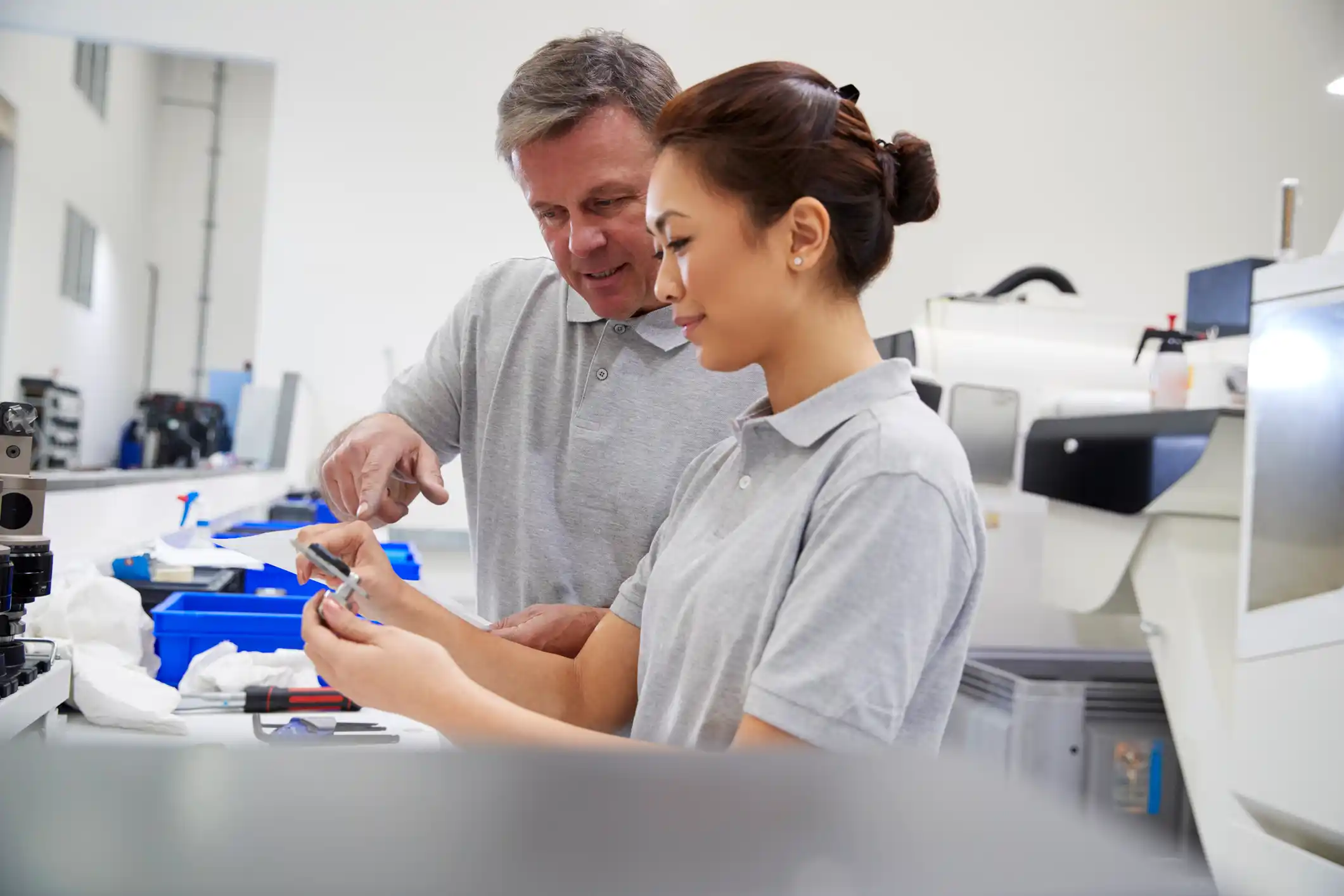 Male And Female Carpenter Working In Woodwork Workshop Talking On Coffee Break