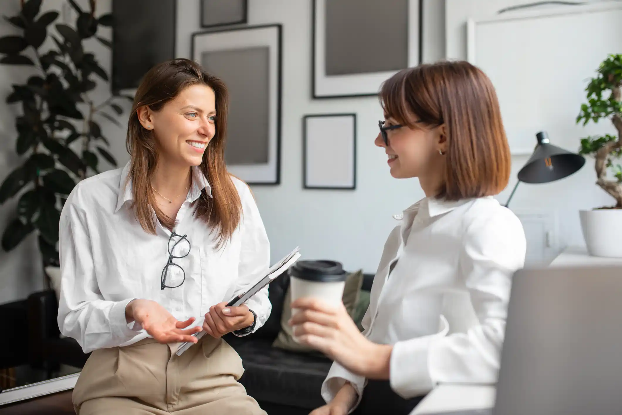 Two women in an office talking
