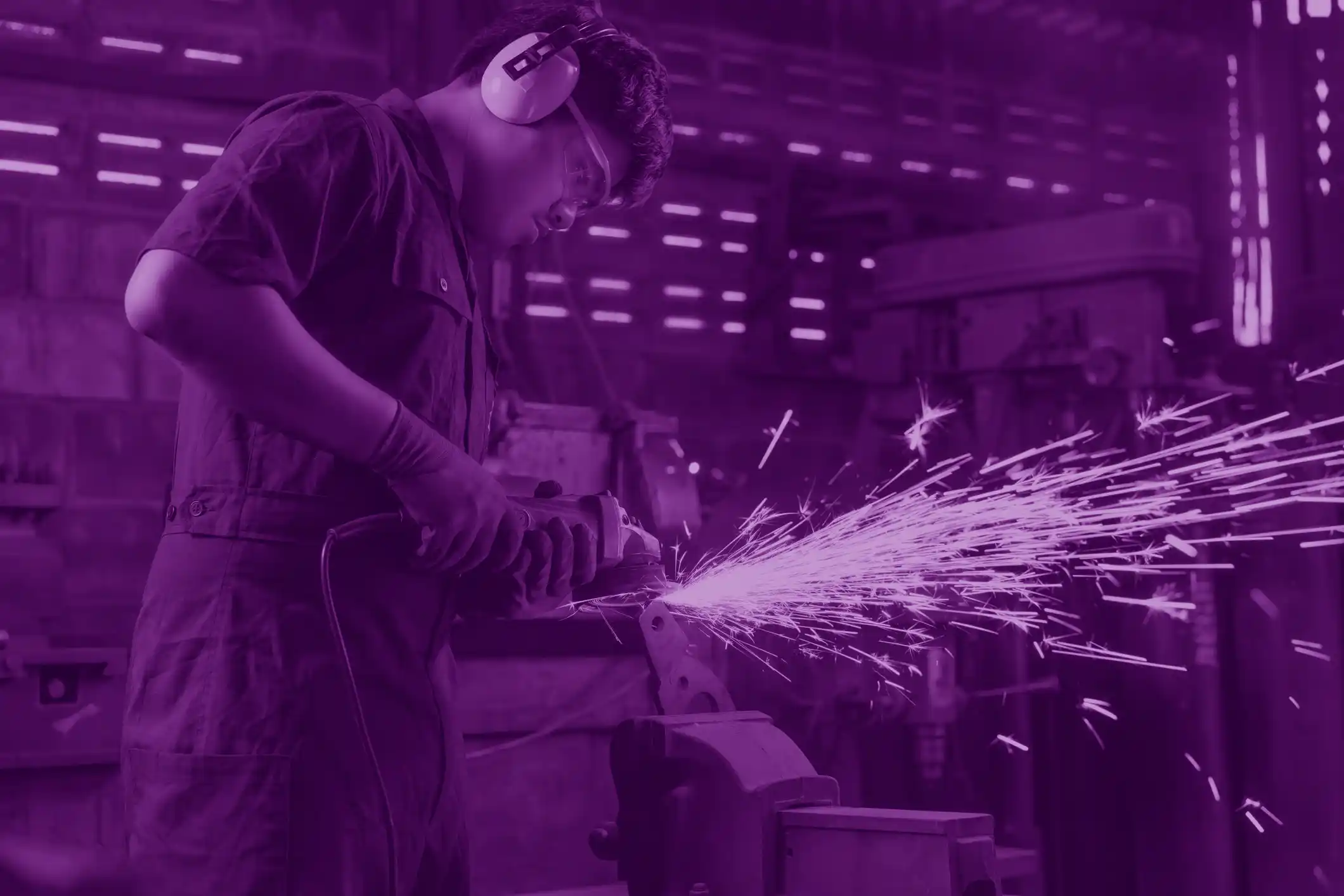 image of engineer using welding tool, tinted purple