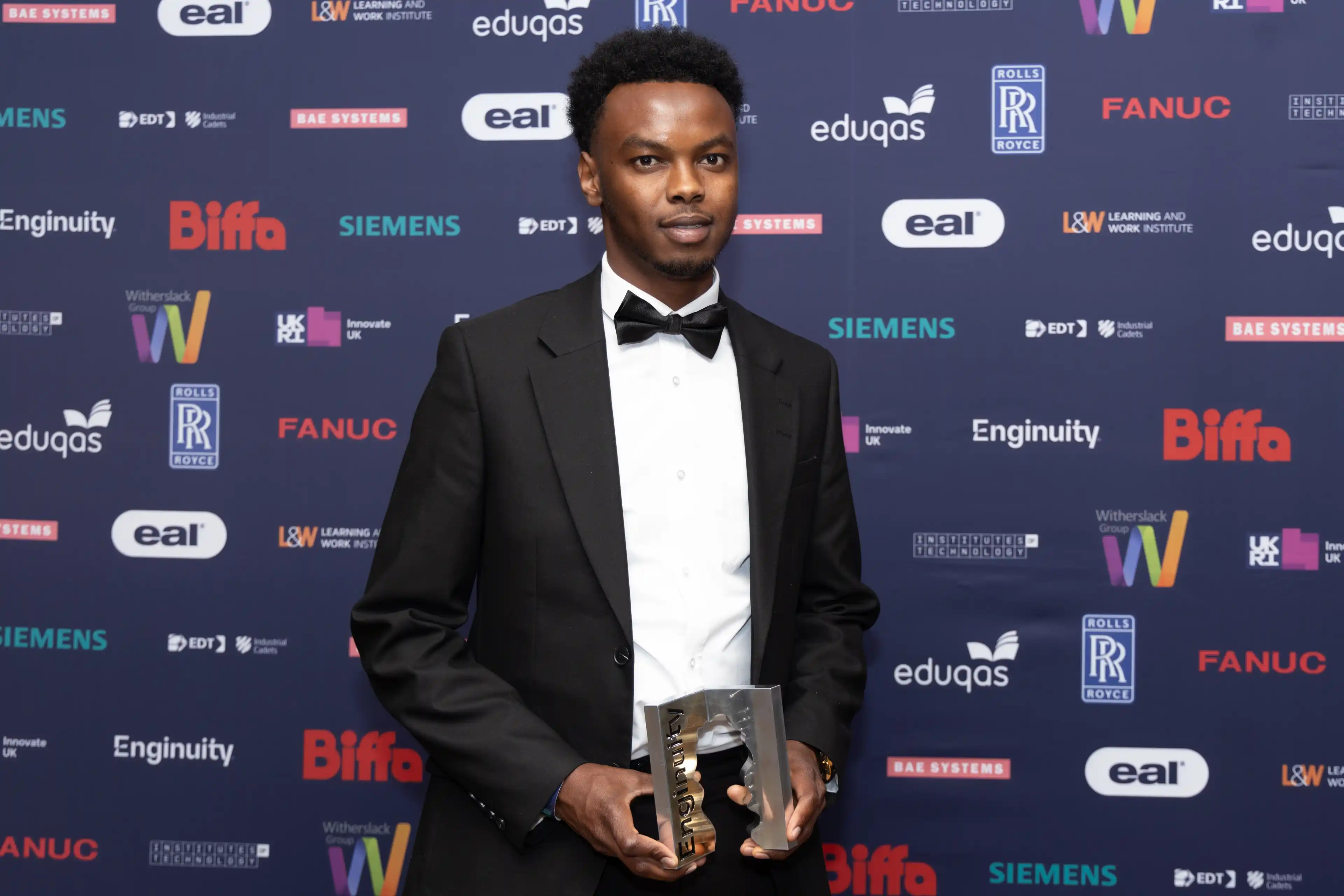 A picture of an award winner collecting their award for T Level student of the year