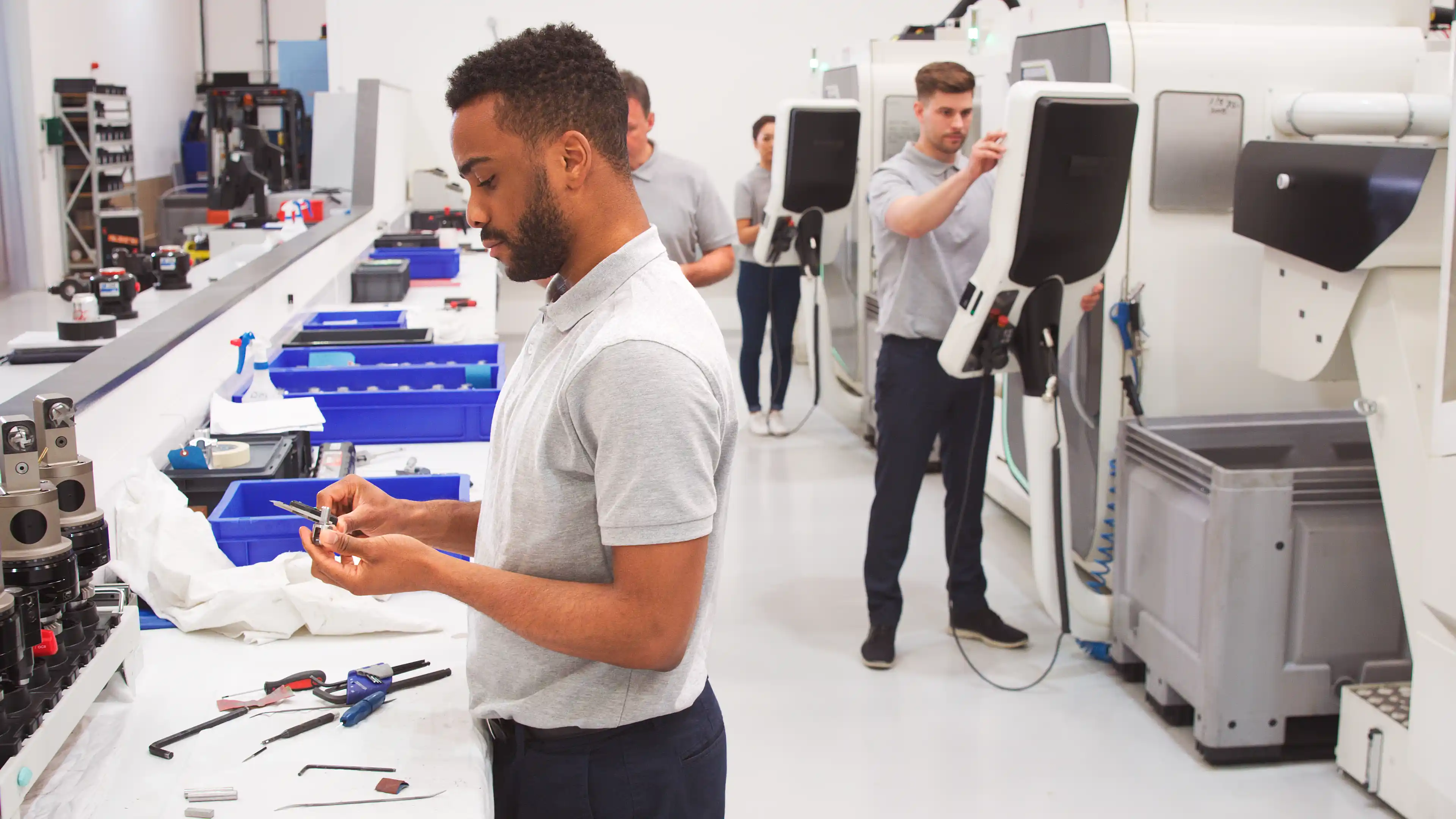 Male Engineer Measuring Components In Hi Tech Engineering Plant stock photo