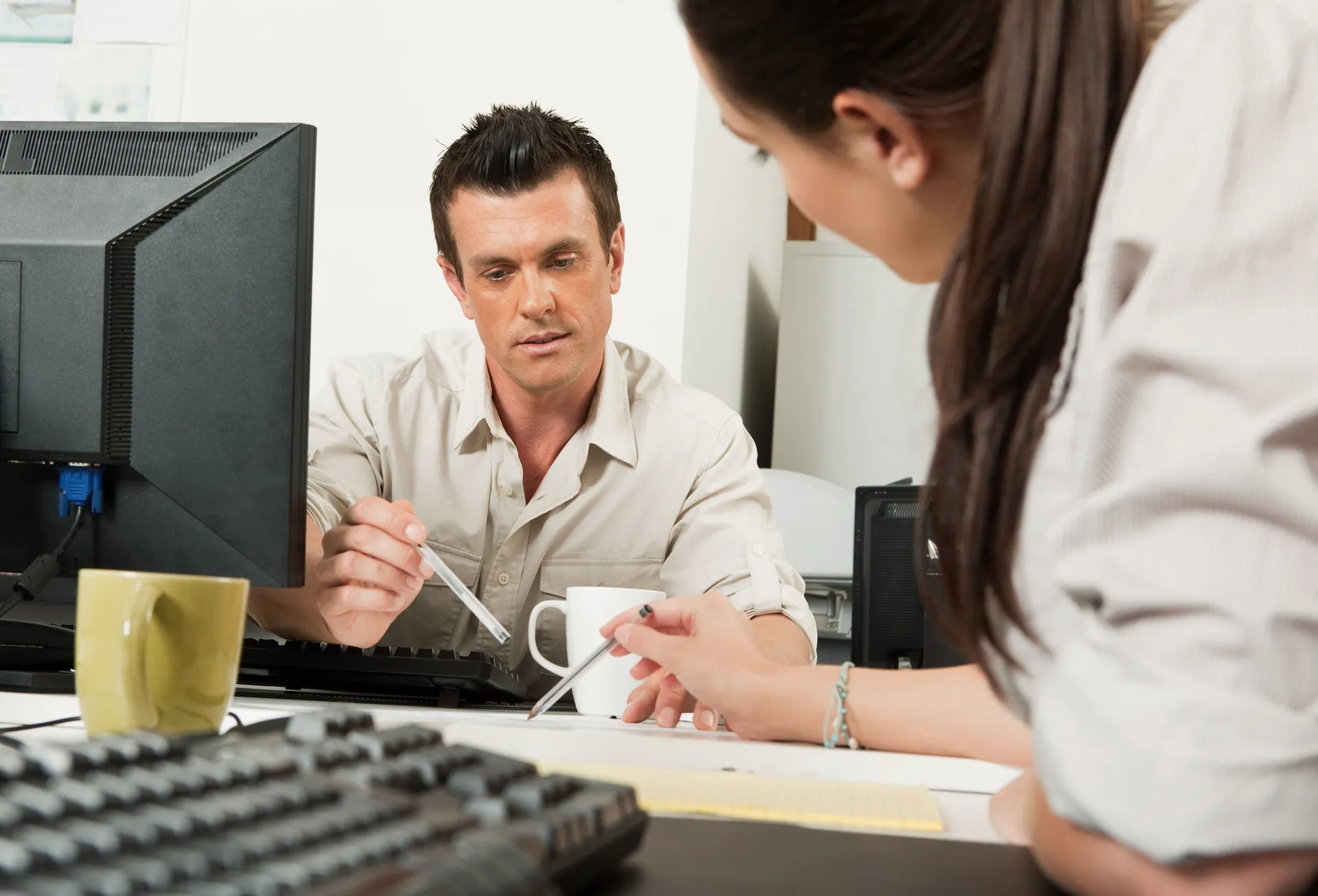 student and teacher talking in office