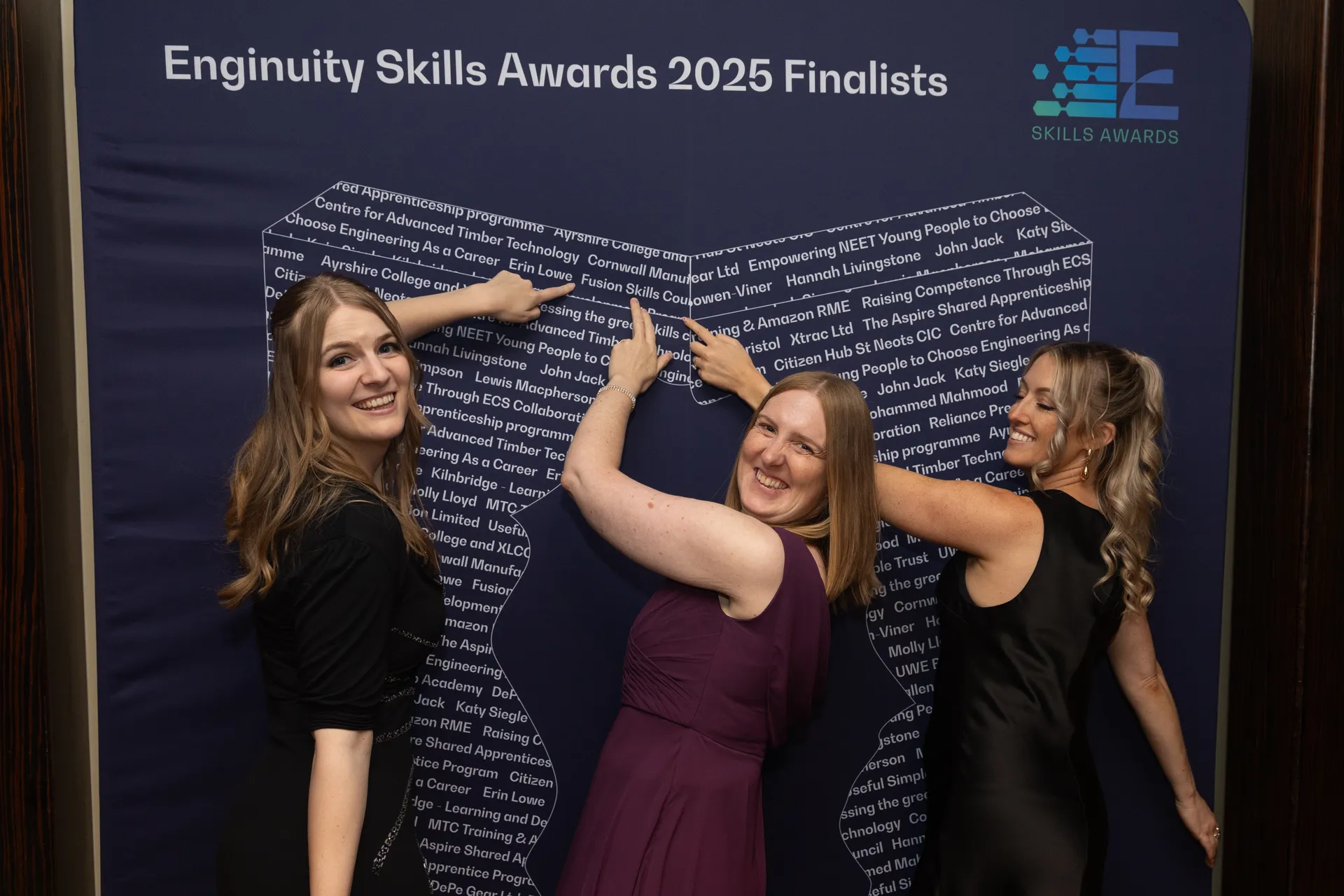 Skills Awards 2025 finalists smiling in front of full list of finalists sign