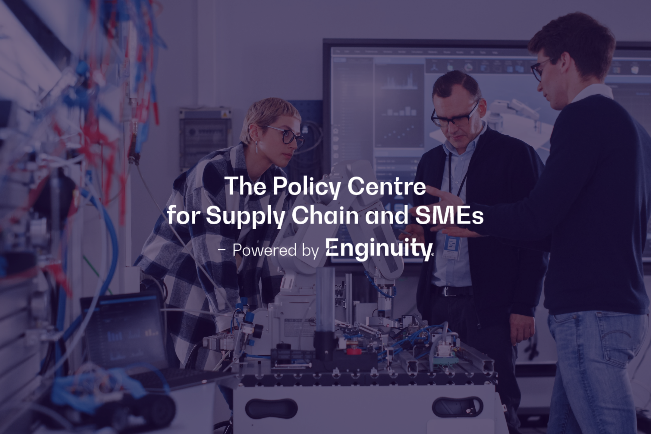 Three workers collaborating in an engineering lab