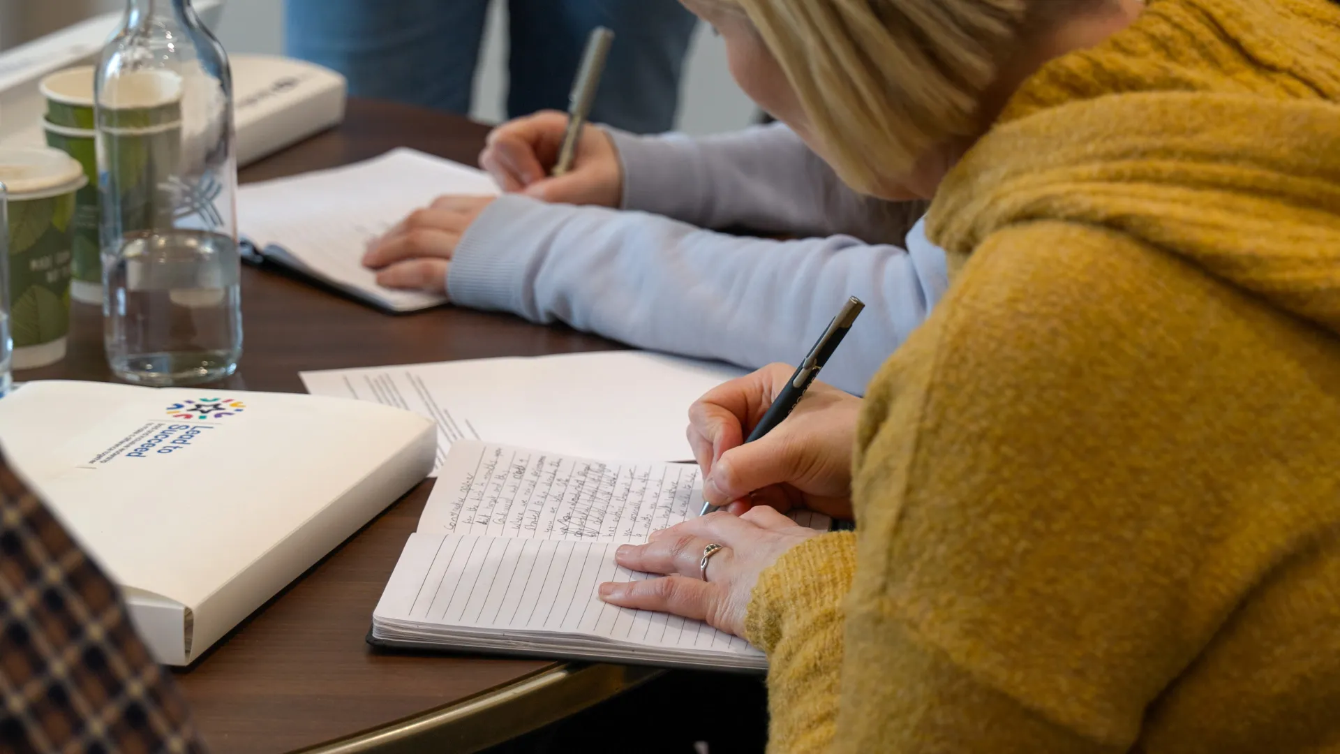Lead to Succeed participant writing notes