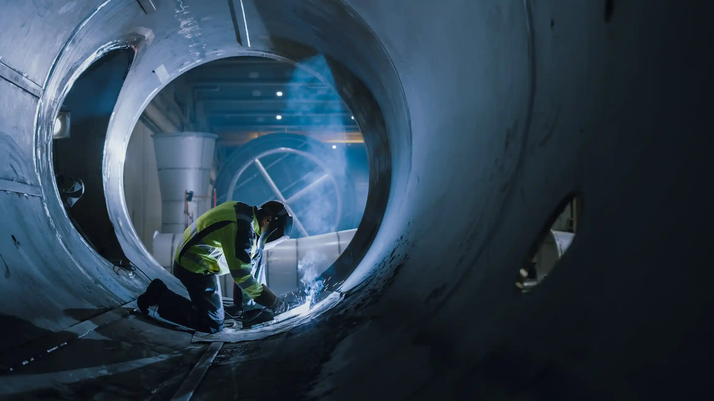 Welder working inside pipe