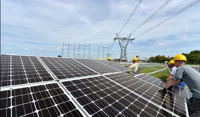 People working on solar panels