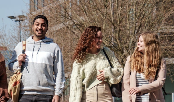 Four students walking on the VU campus square