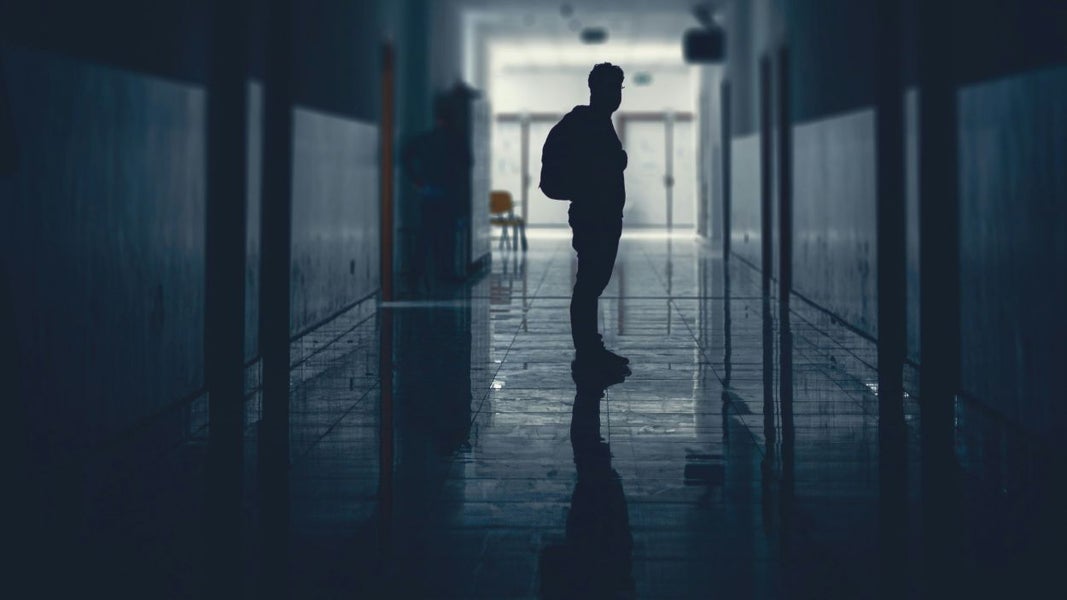 Lonely student standing in corridor