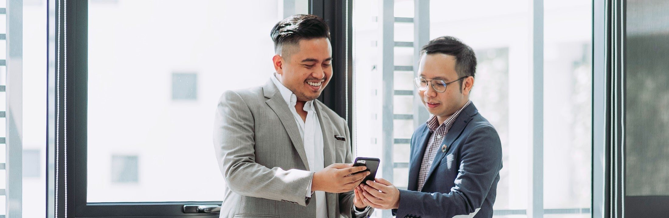 two men looking at mobile phone