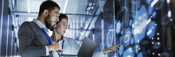 Two people looking at a futuristic screen