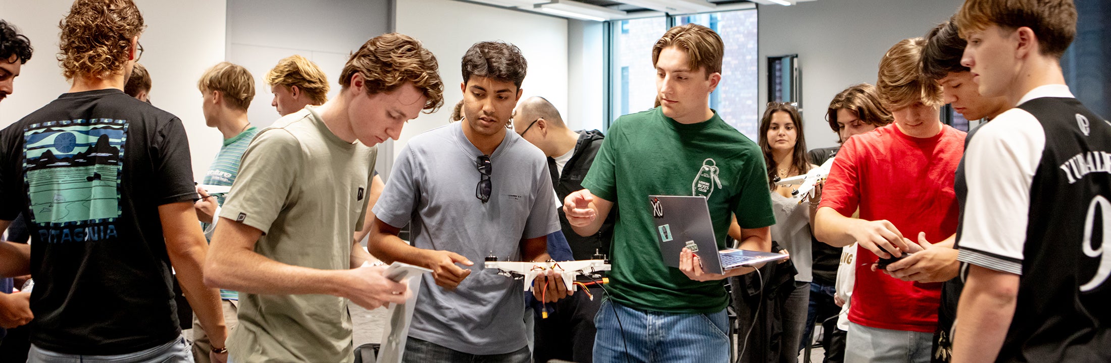A group of students looking at a small done