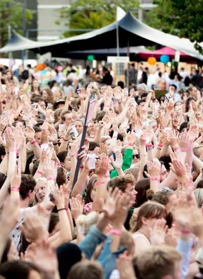 people clapping with their hands in the air