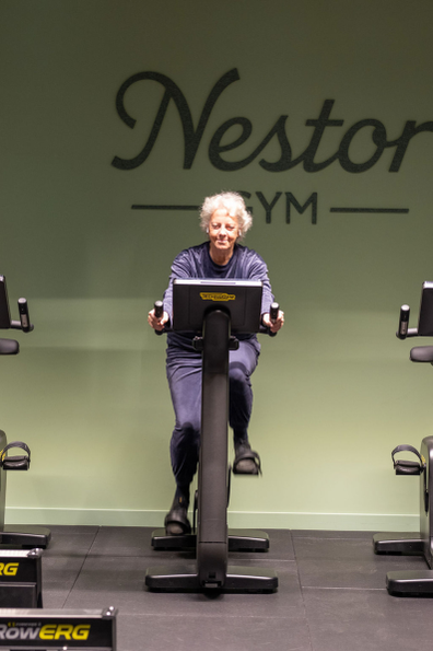 Oudere vrouw indoor fietsend op een hometrainer