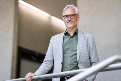 A man in a suit and glasses