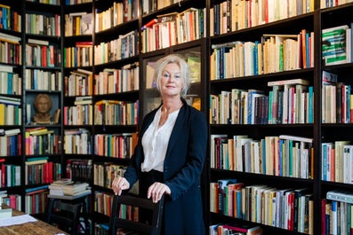 A woman in front of bookcases