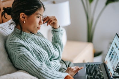 student sitting on the couch with her laptop