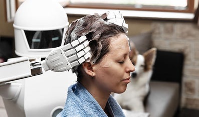 Robot washes hair from a human