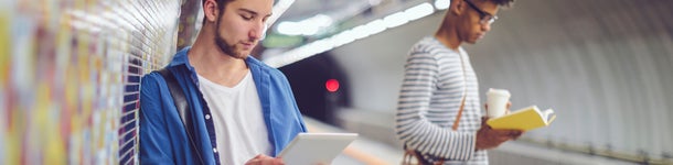 Two guys on the platform of a metro station
