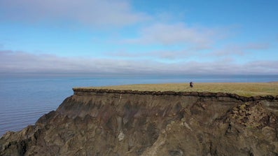 Two people standing on a cliff