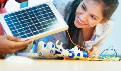 Woman looks at mini solar panel