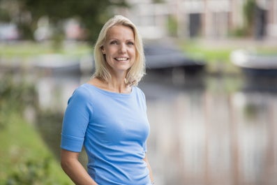 A woman smiles at the camera