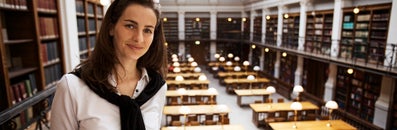 Student with a library in the background