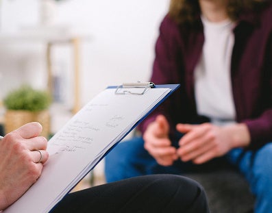 Person writing on a notepad