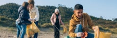 Different generations of people gather litter in nature