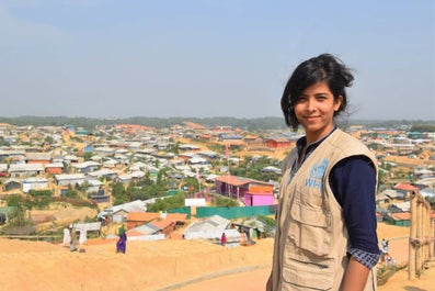 Young person with WHO-vest standing on a view point