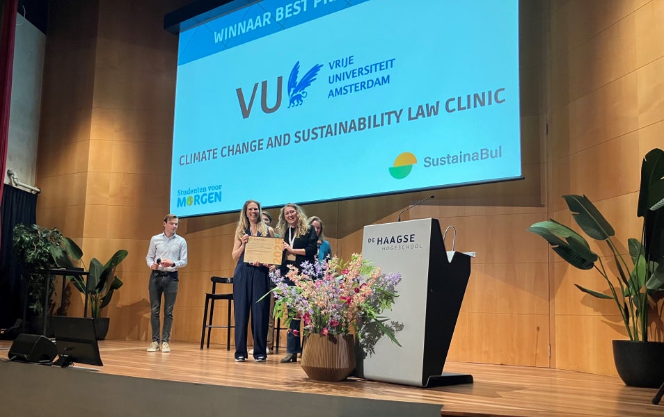 A group of people on a stage during an awards ceremony.