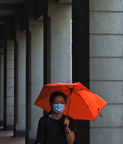 woman with mask and umbrella during covid pandamic