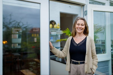 A woman next to a glass door