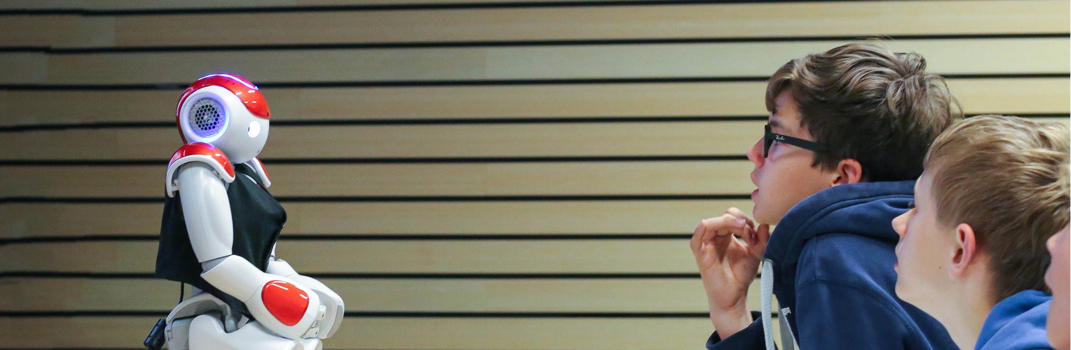 Kids studying a robot