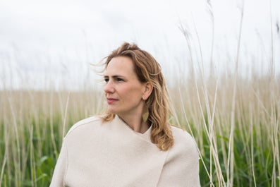 A woman in a field of tall grass