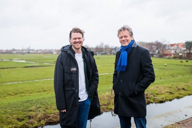 Two men stand side by side