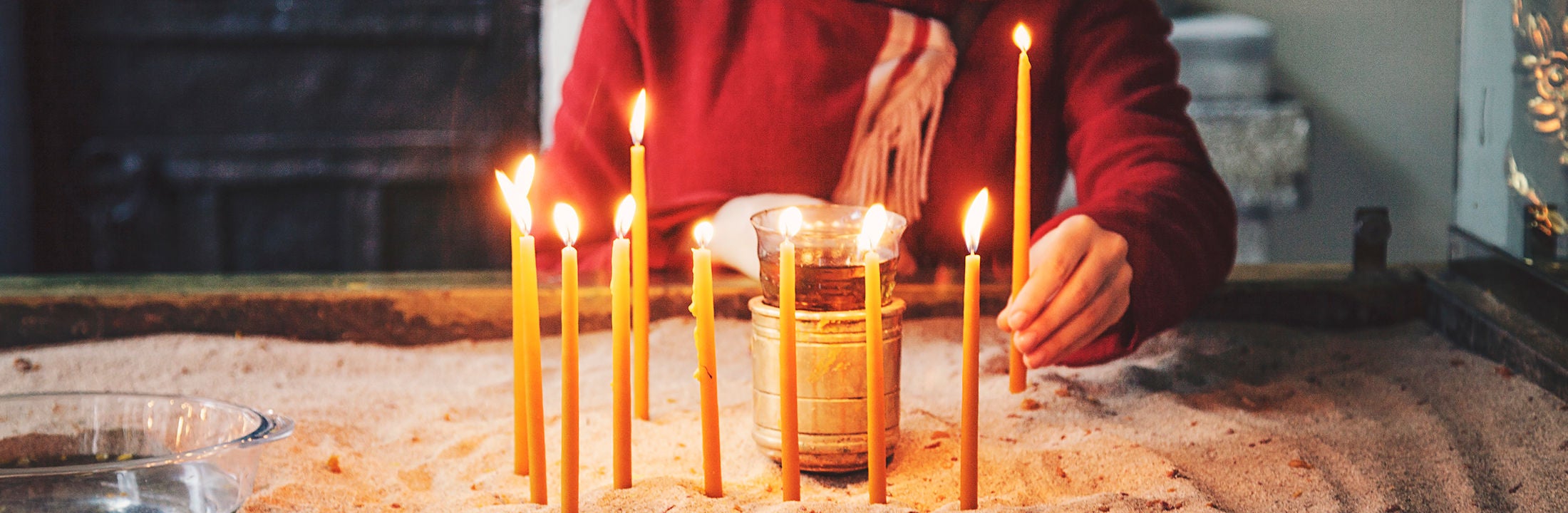 Woman lights candles