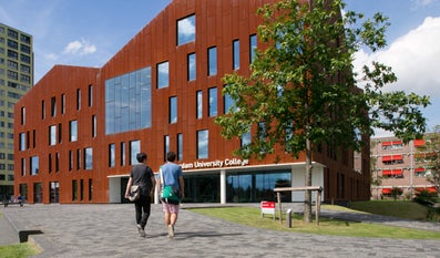 Two students walking towards the entrance of Amsterdam University College