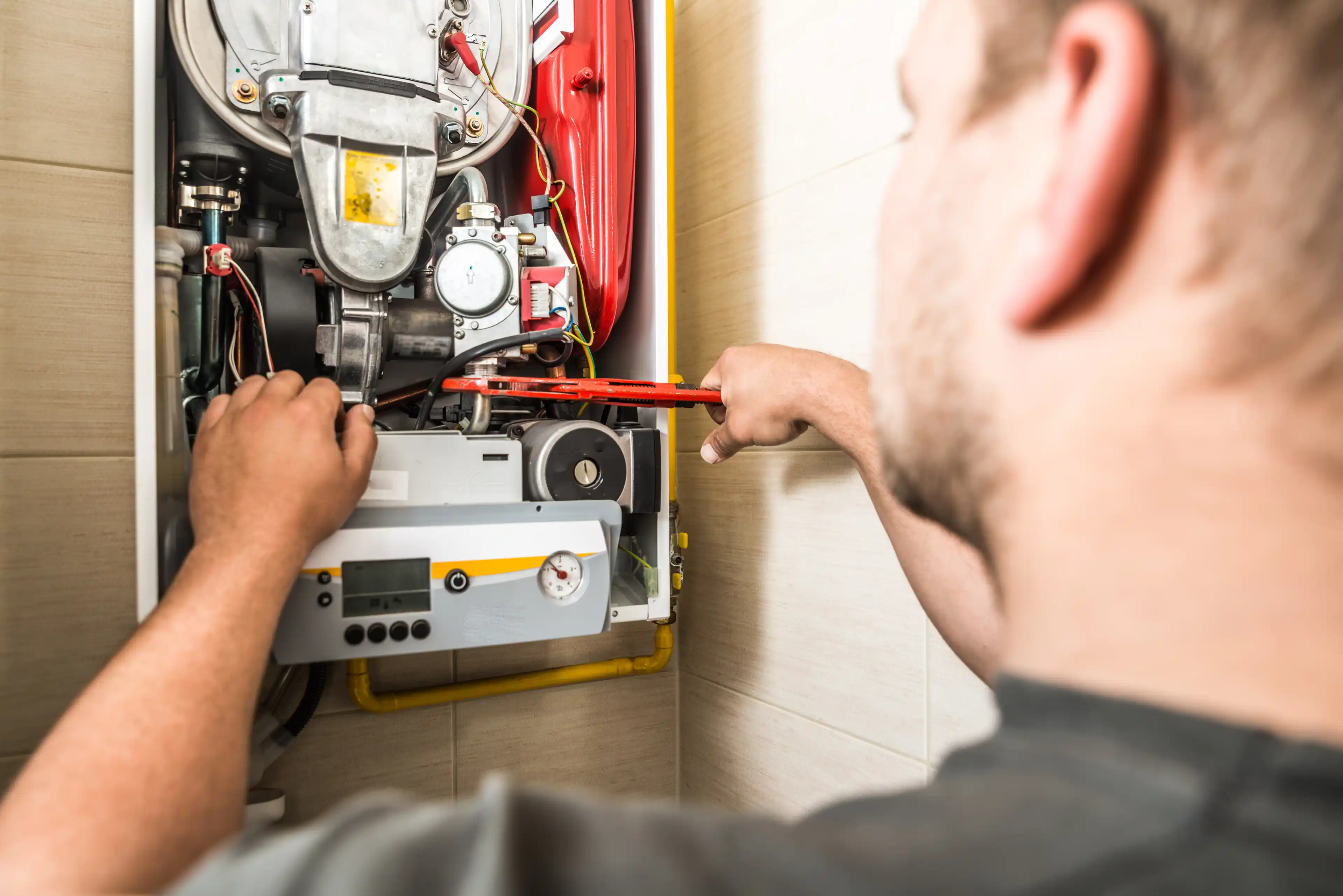 Engineer repairing a boiler