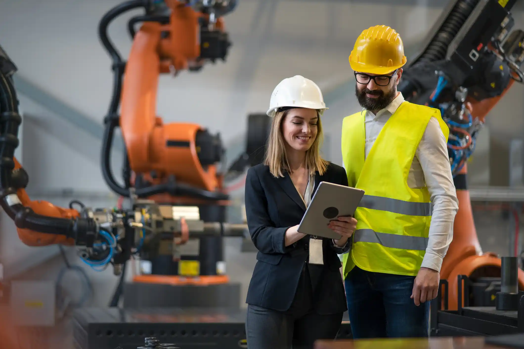 A man and women wearing protective gear on a workshop floor