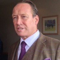 image of Joseph Lloyd, a white male wearing a suit and tie